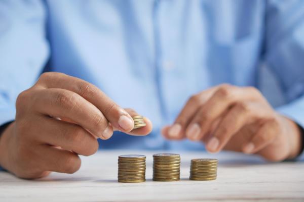 Image of a person stacking coins