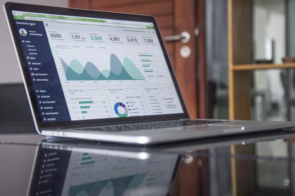 Image of laptop computer with chart background on screen